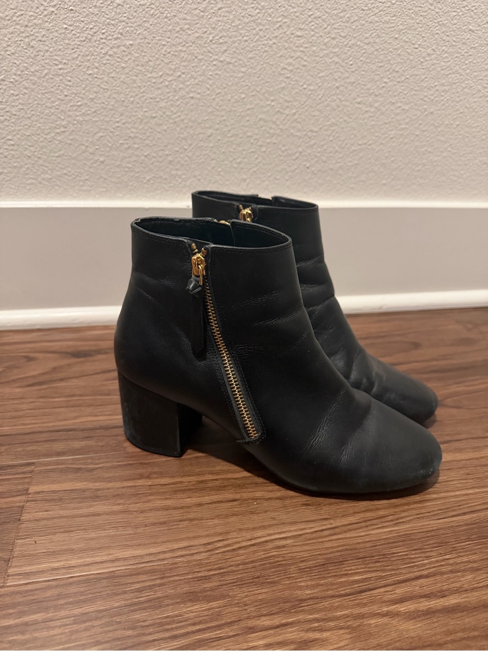 Cole Haan Black Leather Ankle Booties with Gold Zipper Accent